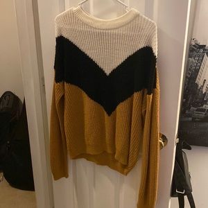 Orange sweater with white and black on the front.